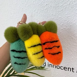 Detailed view of carrot plush keychains in mint green, yellow, and orange faux fur textures