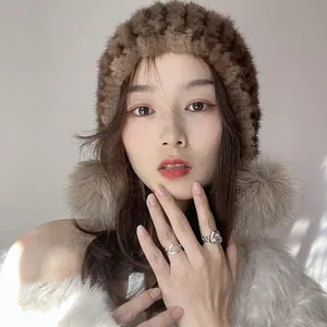 Winter brown mink fur hat and plush coat with elegant silver heart rings for women