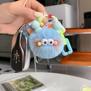 Cute light blue plush monster keychain with letter beads and a white plastic clip