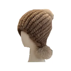Winter mink fur hat for women with fluffy fox fur pom-poms and warm knitted earflaps