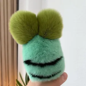 Close-up of soft faux fur cartoon frog plush pendant with vivid mint green texture