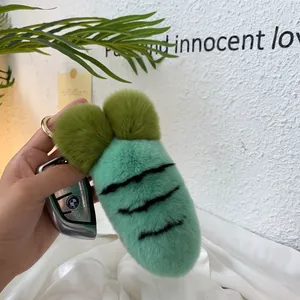 Close-up of mint green plush carrot keychain with soft fur and golden ring holder
