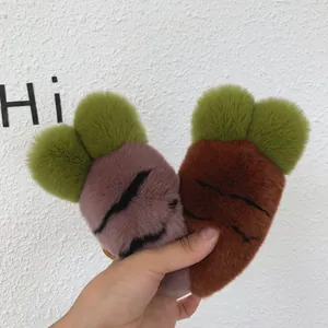 Close-up of soft purple and brown plush carrot keychains with fluffy green leaves