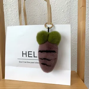 Detail of creative purple plush carrot keychain with green leaves on a white bag