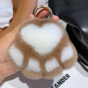 Plush brown and white faux fur cat paw keychain with a golden metallic ring for bags
