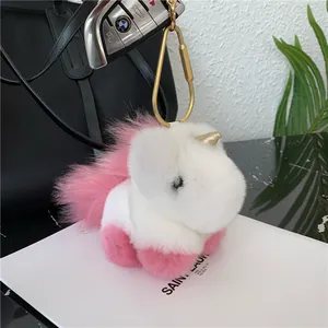 Detail of plush unicorn keychain with fluffy faux fur and a golden metal carabiner