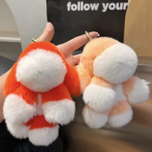 Gros plan de deux porte-clés lapin en peluche orange et pêche avec fermoirs dorés