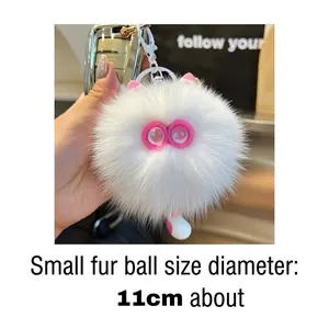 Close-up of fluffy white cat fur ball keychain with pink ears, diameter approx. 11cm