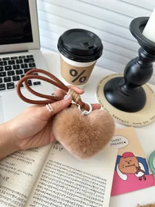 Detailed close-up of a brown fluffy heart keychain with a thick woven rope lanyard