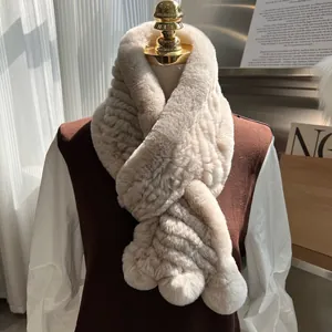 Detail of beige faux rabbit fur scarf showing ribbed texture and cross-over design style