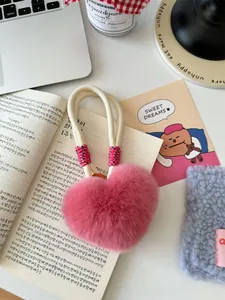 Pink heart-shaped rabbit fur keychain charm with soft woven rope and fluffy texture