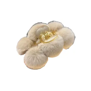 Large beige faux rabbit fur claw clip with plush pom-pom design for women hair styling