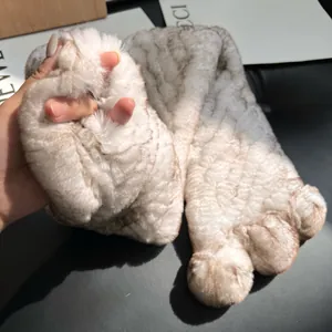 Detail of plush faux fur slippers in animal claw shape with soft texture and thick sole