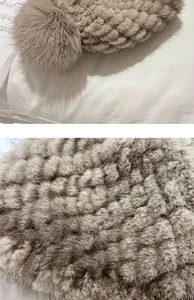 Detail of light brown mink fur hat showing thick knit texture and fluffy fox fur pompom