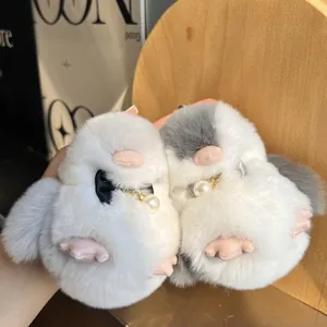 Dettaglio dei ciondoli a pinguino in peluche con fiocchi di perle e pelliccia
