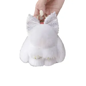Portachiavi con coniglietto di peluche bianco con fiocco glitterato e anello dorato