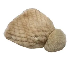 Winter children's knitted mink fur hat in camel brown with fox fur pom pom and ear flaps