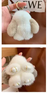 Close-up of fluffy mink fur rabbit charm with golden hardware and leather detail