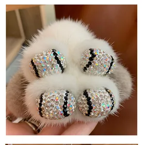 Close-up of a white mink fur rabbit keychain with sparkling rhinestone detailing