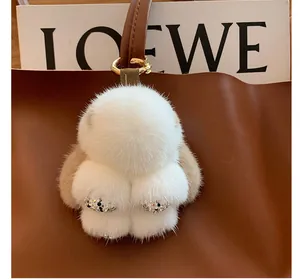 Detail of plush mink fur rabbit charm with rhinestone paws and leather strap