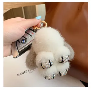Detail of plush mink fur rabbit keychain with rhinestone paws and gold metal ring