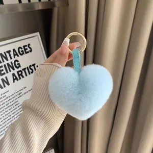 Light blue heart-shaped faux rabbit fur keychain with gold spring ring clasp and leather strap