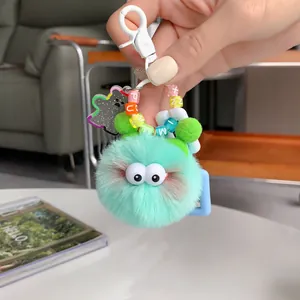 Cute mint green faux mink fur monster keychain with letter beads and large eyes charm