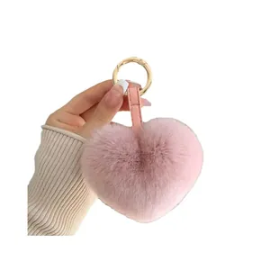 Pink heart-shaped plush keychain in soft faux rabbit fur with golden metal ring