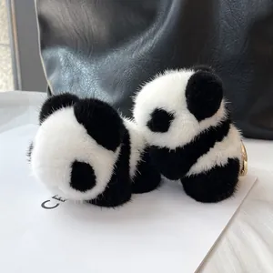 Detail of soft real mink fur panda charm with a luxury gold metal keychain clip
