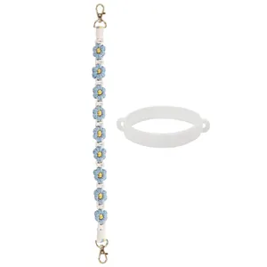 Détail de la sangle à fleurs tissée et de l'anneau en silicone pour gobelet en acier