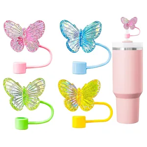 Laser butterfly straw toppers in four colors for reusable cups shown on white background