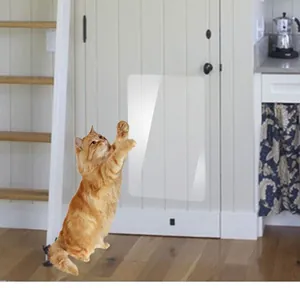 Transparent PVC cat scratch protector guard applied on white wooden door surface