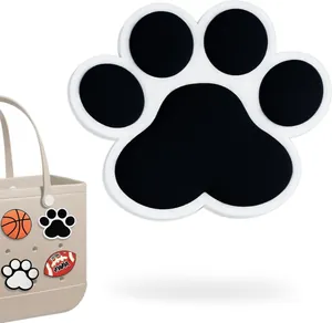 Détail du charm en forme de patte noir et blanc pour sacs de plage EVA ajourés