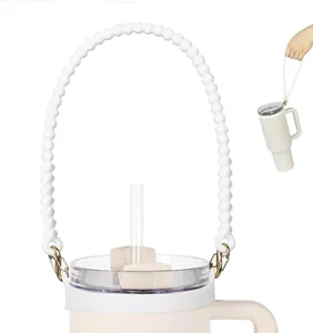 Close-up of white silicone beaded water bottle strap with gold metal carabiners for tumbler