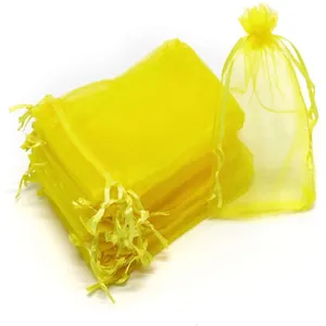 Bright yellow mesh organza drawstring bags for fruit protection and gift packaging