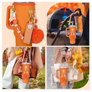 Orange accessories for Stanley tumblers including woven strap and heart charms set