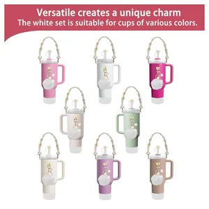 White Stanley cup accessory set with daisy straw cover and pearl handle strap