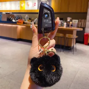Plush black cat head keychain with yellow eyes and gold metal clip on car keys