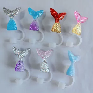 Flat lay of seven colorful sequined mermaid tail silicone straw covers for tumblers