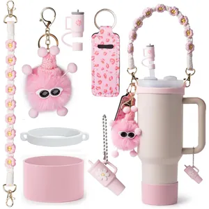 Detail of pink silicone cup boot, floral handle strap and cute plush charm on tumbler