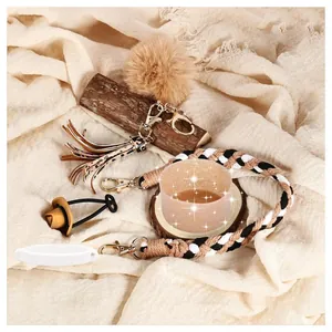 Boho Stanley cup accessory set with woven wristlets, leopard tassel, and fuzzy pompom charms