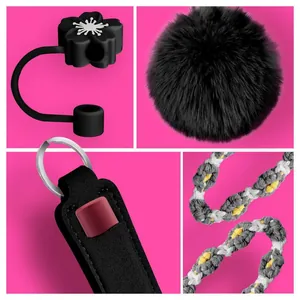 Detail of 4-piece Stanley cup accessory set with black pompom and woven strap