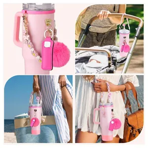 Pink 40oz tumbler set with letter charms, woven floral handle, and fuzzy pompom keychain