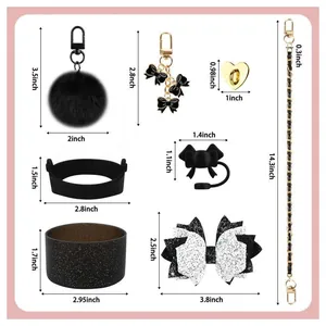 Black and gold Stanley cup accessories set including bow charms and silicone boots