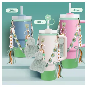 Trio of 20oz 30oz and 40oz tumblers with letter charms and floral accessories