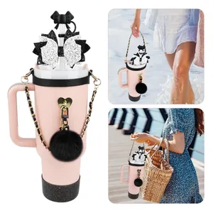 Pink insulated tumbler with black sequin bow cover, gold chain and plush keychain charm