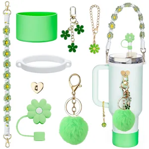 Green and white Stanley cup accessory kit with silicone sleeve and flower charms