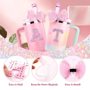 Detail view of pink bow straw cover and rhinestone letter charms for Stanley cups