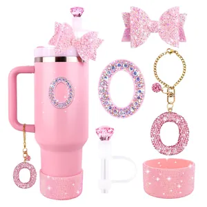 Pink tumbler accessories set with glitter bows, rhinestone straw covers and protective boot