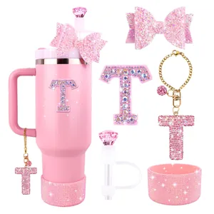Close-up of pink glitter bow straw topper and personalized letter T rhinestone charm for cup